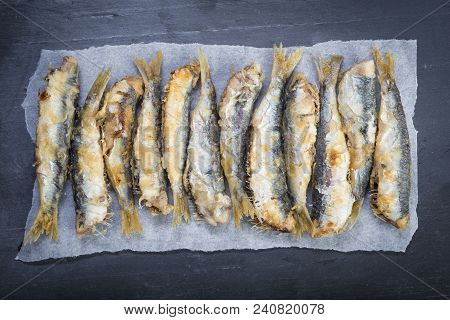Fried Sardines On A Slate Background