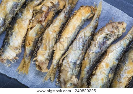 Fried Sardines On A Slate Background