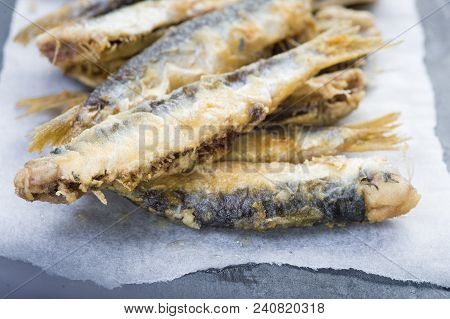 Fried Sardines On A Slate Background