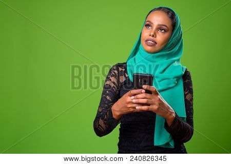 Studio Shot Of Young African Woman Wearing Traditional Muslim Clothing Against Chroma Key With Green