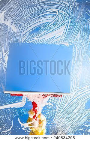 Cleaning Window With Squeegee Blue Sky. Studio Shot