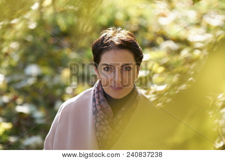 Woman In Autumn Yellow Leaves In Sunset Rays