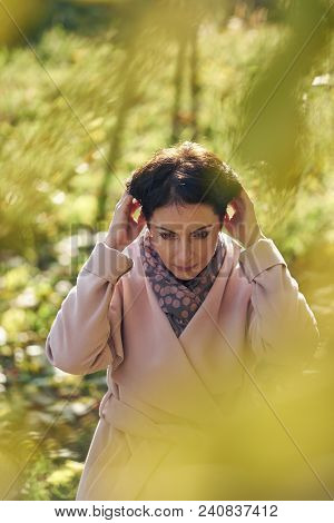 Woman In Autumn Yellow Leaves In Sunset Rays