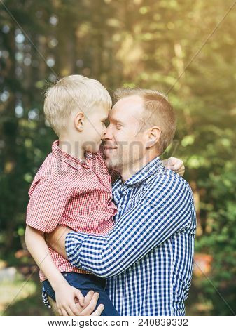 Gentle Embrace Of Father And Son In The Park. Masculinity Concept. Blondy People. Family, Love.