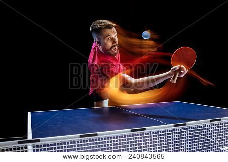 The Table Tennis Player In Motion. Fit Young Sports Man Tennis-player In Play On Black Background Wi