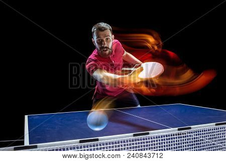 The Table Tennis Player In Motion. Fit Young Sports Man Tennis-player In Play On Black Background Wi