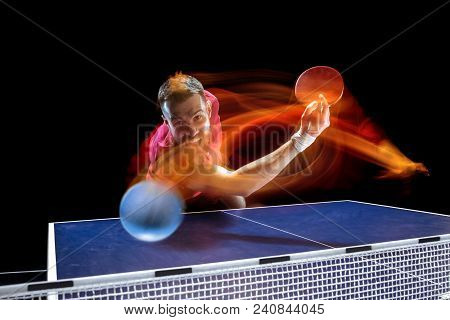 The Table Tennis Player In Motion. Fit Young Sports Man Tennis-player In Play On Black Background Wi