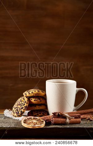 Traditional Christmas Tea Concept With A Cup Of Hot Tea, A Large Set Of Cookies On A Homespun Napkin