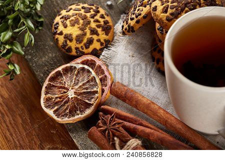 Traditional Christmas Tea Concept With A Cup Of Hot Tea, A Large Set Of Cookies On A Homespun Napkin