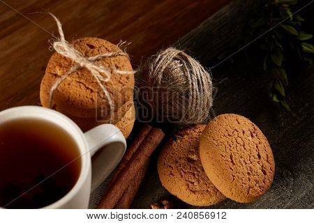 Traditional Christmas Tea Concept With A Cup Of Hot Tea, A Large Set Of Cookies On A Homespun Napkin