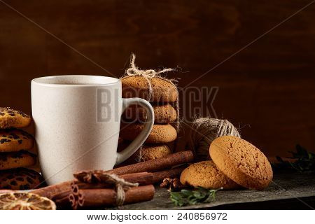 Traditional Christmas Tea Concept With A Cup Of Hot Tea, A Large Set Of Cookies On A Homespun Napkin