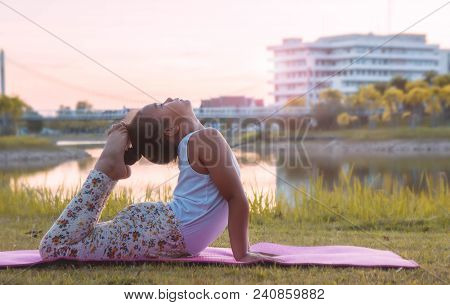 Healthy Yoga Girls And Concentrate In The Park , Kid Yoga Practice For Health In The Nice Day , Yoga