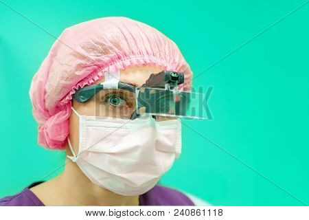Close Up Portrait Of Young Female Surgeon Doctor Wearing Protective Mask And Hat. Healthcare, Medica