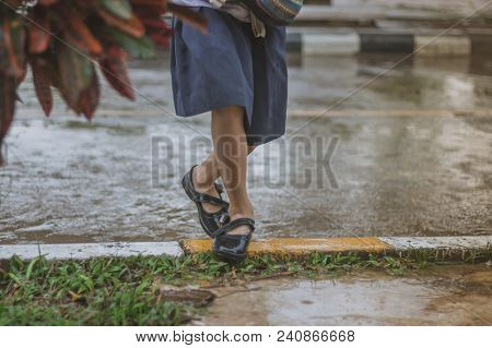 Students Walk To The Flood After Rain In School.