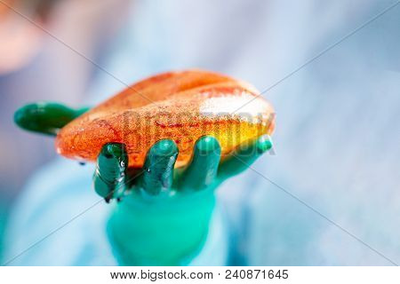 Surgeon Preparing Breast Silicone Implant For The Operation Of Breast Augmentation