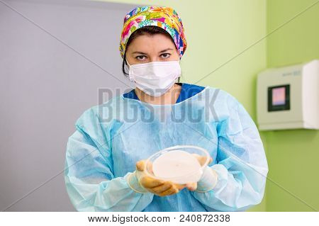 Surgeon Preparing Breast Silicone Implant For The Operation Of Breast Augmentation