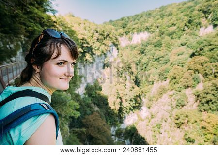 Zeda-gordi, Georgia. Beautiful Woman Posing For Photo On Narrow Suspension Bridge Or Pendant Road Up