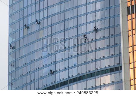 Moscow, Russia - May, 13, 2018: Steeplejacks work on a wall of Moscow city building