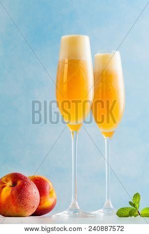 Two Glasses Of Champagne With A Cocktail Of Bellini And Fresh Pe