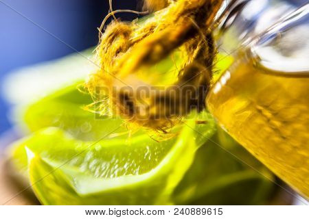 Medicinal And Floral Essence Of Ayurvedic Herb Aloe Vera With Its Leaves In A Transparent Bottle On