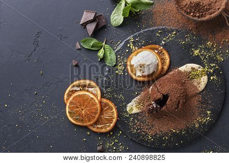 Classic French Dessert. Chocolate Fondant Lava Cake With Custard And Ice Cream On Slate, Citrus And 