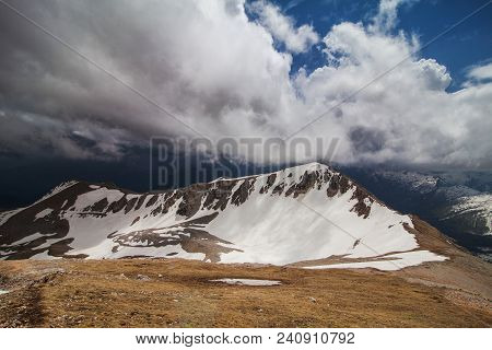 One Of The Snow-capped Peaks Of Mount Oshten, Under A Cloudy Sky