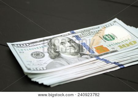 Dollars money cash on black background. Heap of money