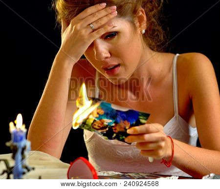 Wedding memories. Broken heart woman. Couple break up. Sad bride on unhappy wedding. Woman and groom quarrel. Portrait crying female. Problems with relationships. She burns photo.