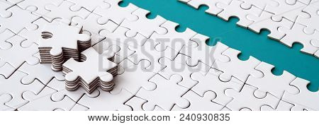 The Blue Path Is Laid On The Platform Of A White Folded Jigsaw Puzzle. The Missing Elements Of The P