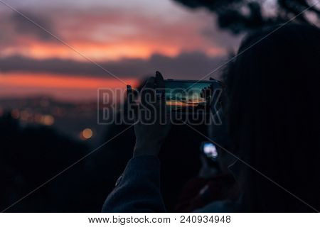 Young Woman Taking Photo With Her Phone