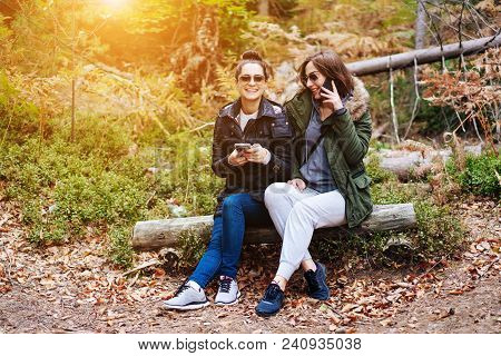 Two Beautiful Girls Sat Down To Rest In The Forest