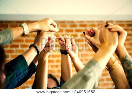 Community group holding hands in support