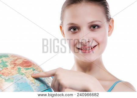 Girl Shows On The Place On The Globe. On A White Background