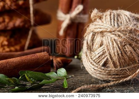 Close-up Still-life Of Cinnamon, Star Anise And Ball Of Yarn On Wooden Background, Shallow Depth Of 