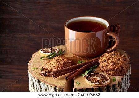 Christmas Concept With A Cup Of Hot Tea, A Large Set Of Cookies, Cinnamon Sticks Bunch, A Couple Of 