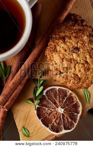 Christmas Concept With A Cup Of Hot Tea, A Large Set Of Cookies, Cinnamon Sticks Bunch, A Couple Of 
