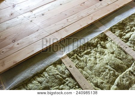 Installation Of New Floor Of Wooden Natural Planks And Mineral Wool Insulation For Isolation And Kee