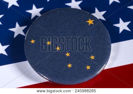London, Uk - April 27th 2018: The Symbol Of The State Of Alaska, Pictured Over The Flag Of The Unite