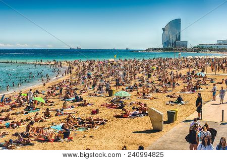 Barcelona - August 10: People Enjoying A Sunny Day On La Barceloneta Beach, Barcelona, Catalonia, Sp