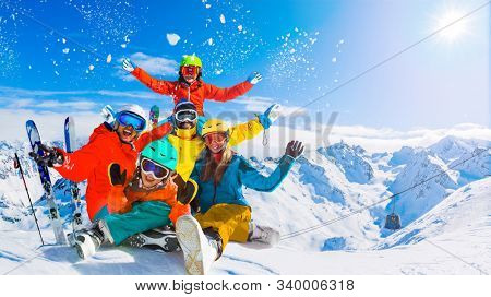 Happy family enjoying winter vacations in mountains, Val Thorens, 3 Valleys, France. Playing with snow and sun in high mountains. Winter holidays.
