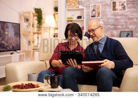 Beautiful Old Couple Using A Digital Tablet To Chat With Their Family