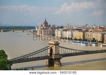 View Of Historical Building Of Hungarian Parliament And Chain Bridge On Danube River In Budapest, Hu