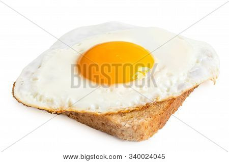 Single Fried Egg With Crispy Edges On Wholewheat Toast Isolated On White.