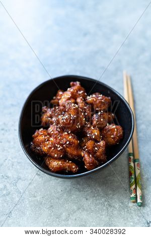 Asian Food Homemade Chinese General Tsos Chicken With Sesame Seeds Served With Chopsticks.