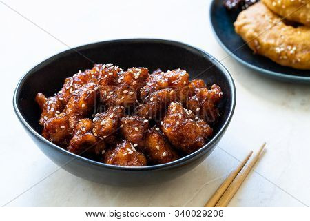 Asian Food Homemade Chinese General Tsos Chicken With Sesame Seeds Served With Chopsticks.