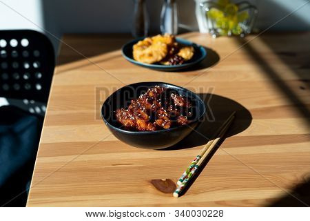 Asian Food Homemade Chinese General Tsos Chicken With Sesame Seeds Served With Chopsticks.