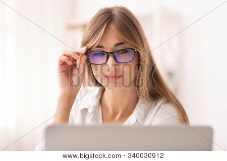 Poor Eyesight. Businesswoman In Eyeglasses Squinting Eyes Working At Laptop Looking Through Eyeglass
