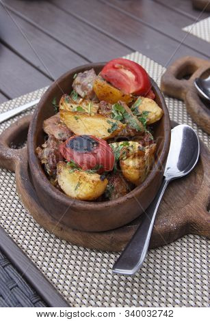 Roasted Meat With Potatoes, Ojaxuri, Hot In Georgian On A Wooden Table. Georgian Cuisine
