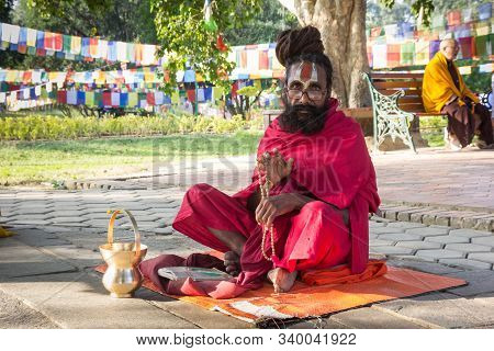 Lumbini, Nepal - November 09, 2019: Traditional Monk Giving His Blessing At The Mayadevi Temple In L