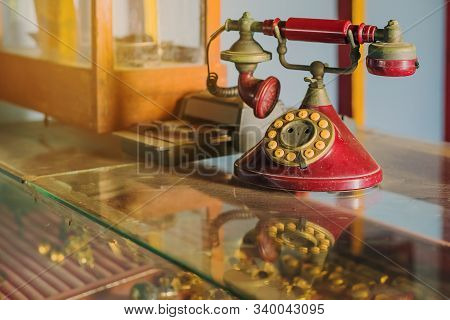A Red Telehones With Rotary Dial With Dust And Scratches And Credit Card Machine In Ancient Times Pl